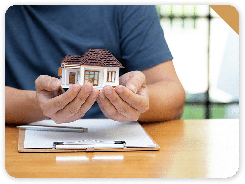 home loan concept, man holding model house